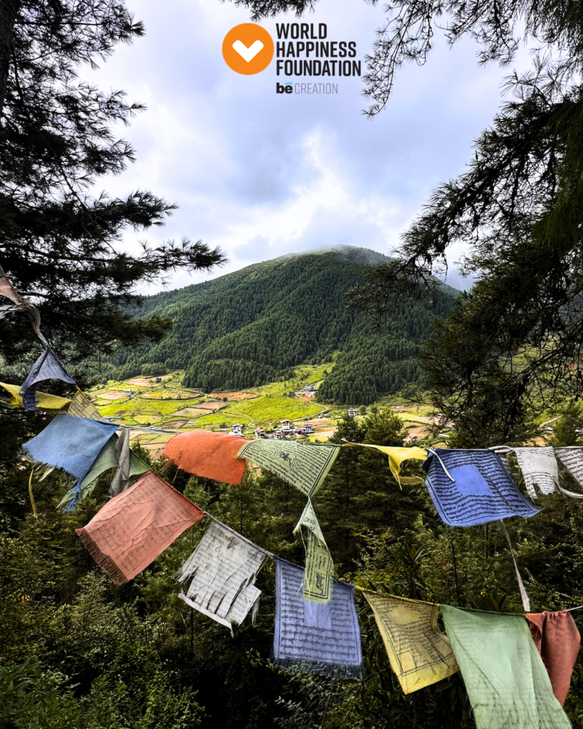 Prayer flags above a green Bhutanese valley