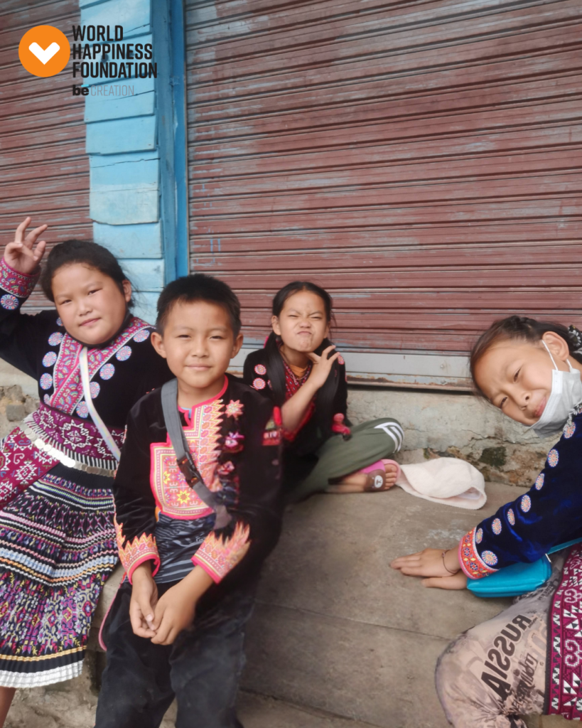 Children in traditional embroidered dress playing in the street
