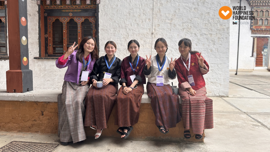 Bhutanese students in traditional kira outside a whitewashed dzong