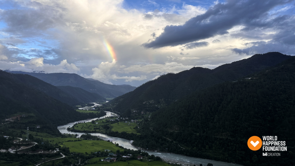 Paro valley with a rainbow over the river and forested hills
