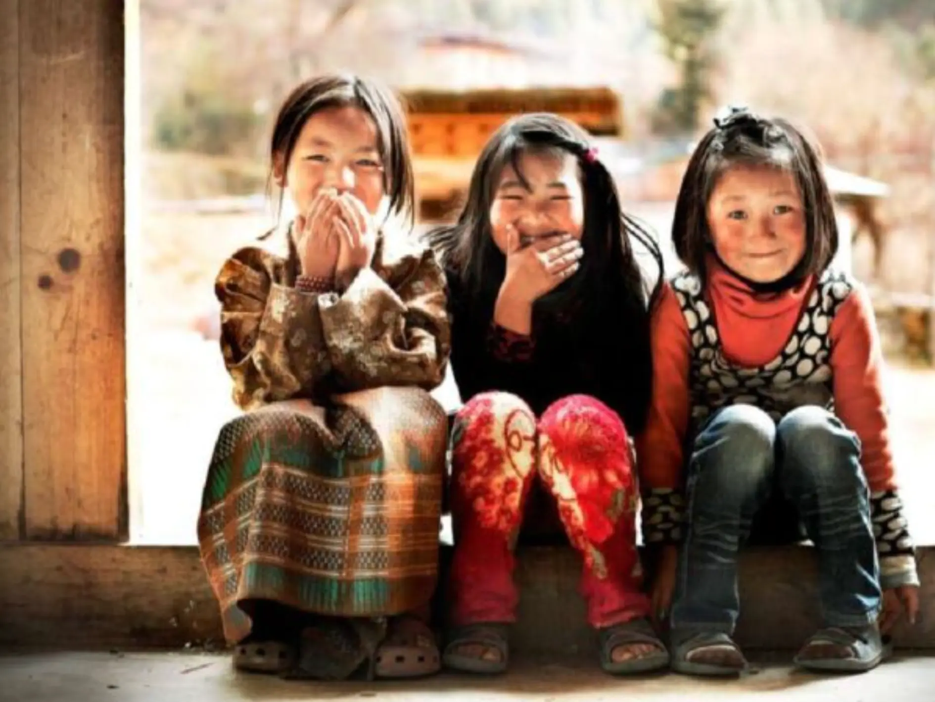 Children in Bhutan smiling together outdoors
