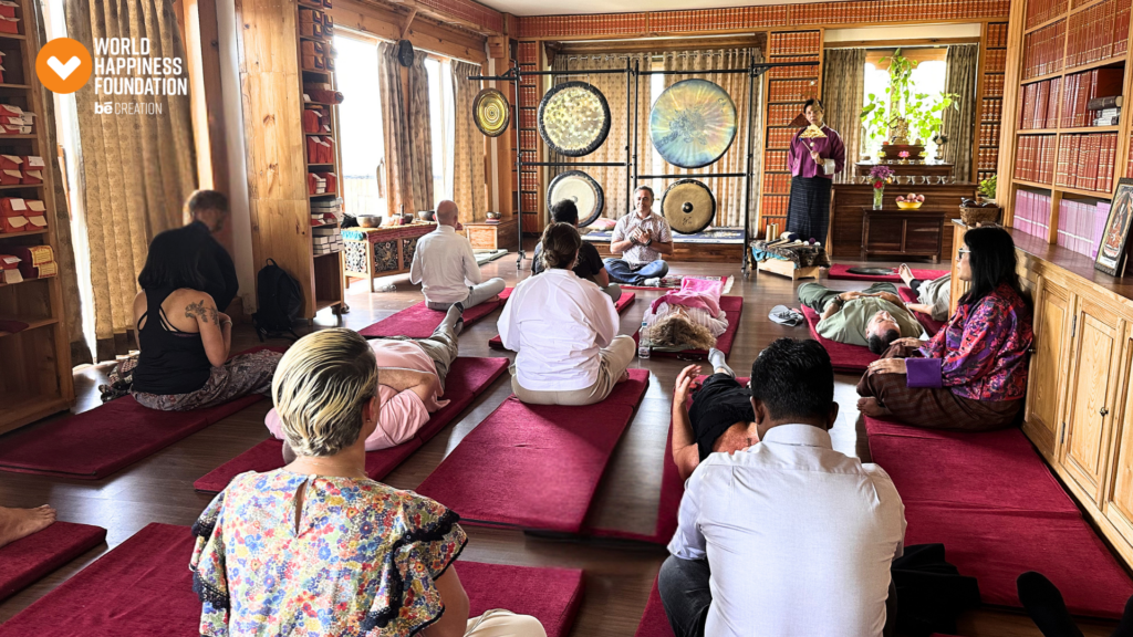 Expedition group in a sound-healing session with gongs in a Bhutanese hall