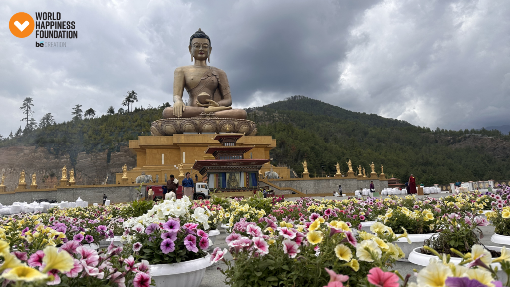 Buddha Dordenma statue above Thimphu with flowers in the foreground