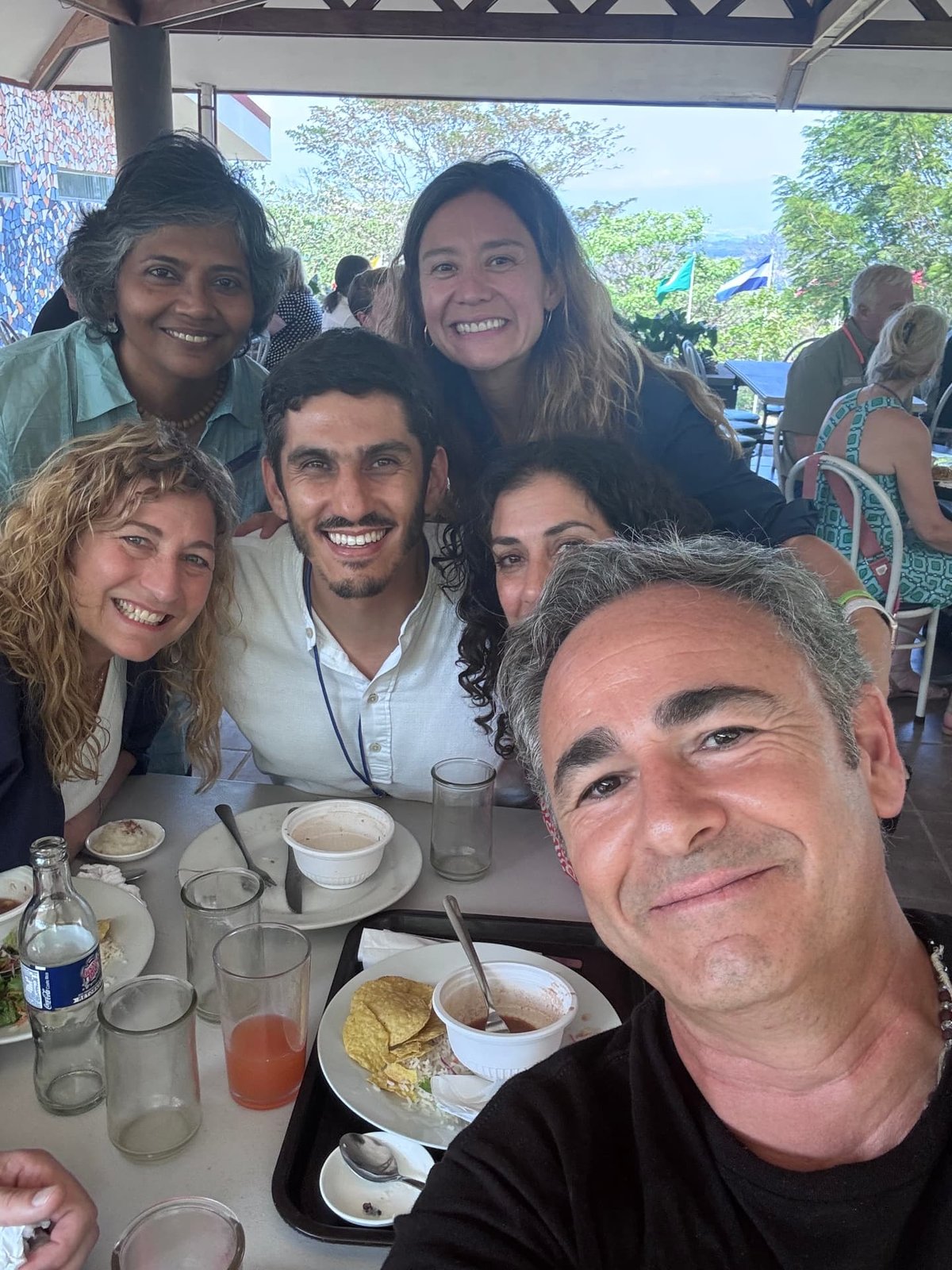Six members of the Foundation community smiling around a lunch table