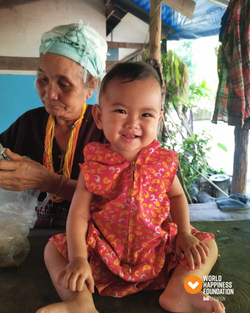 A grandmother and smiling child at home in a village